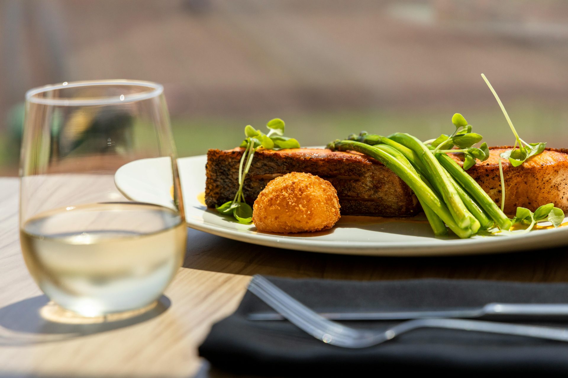 Elegant gourmet salmon dish paired with white wine, perfect for fine dining.